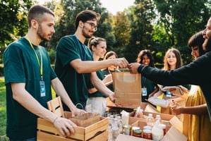 Nonprofit team handing out packages of food and charity gift cards