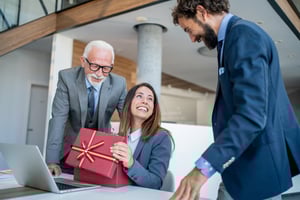 Office employee receiving gift card as corporate holiday gift