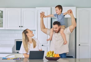Happy healthy employee working at home with her family