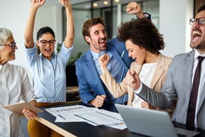Engaged employees cheering and showing high morale