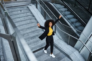 Happy, healthy employee taking the stairs to work