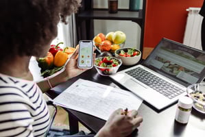 Employee looking at her health and wellness plan schedule at her workplace desk
