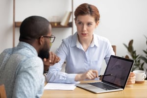 Manager discussing employee performance with team member