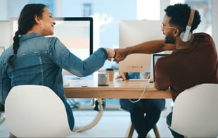 Two employees congratulating each other