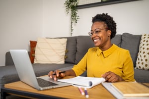 Happy, productive remote employee working from home living room