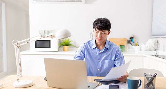 Asian man working on computer 