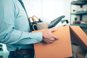 Frustrated employee packing up their desk and quitting