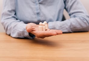 Manager holding employee figurines to represent talent retention