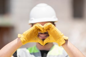 Employee wearing PPE and supporting safety and wellness in the workplace