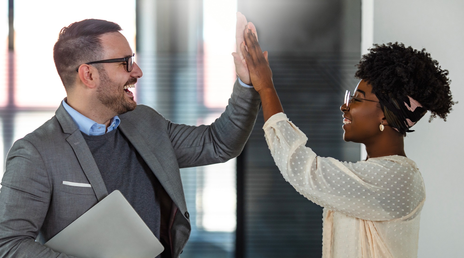 Business owner high-fiving employee