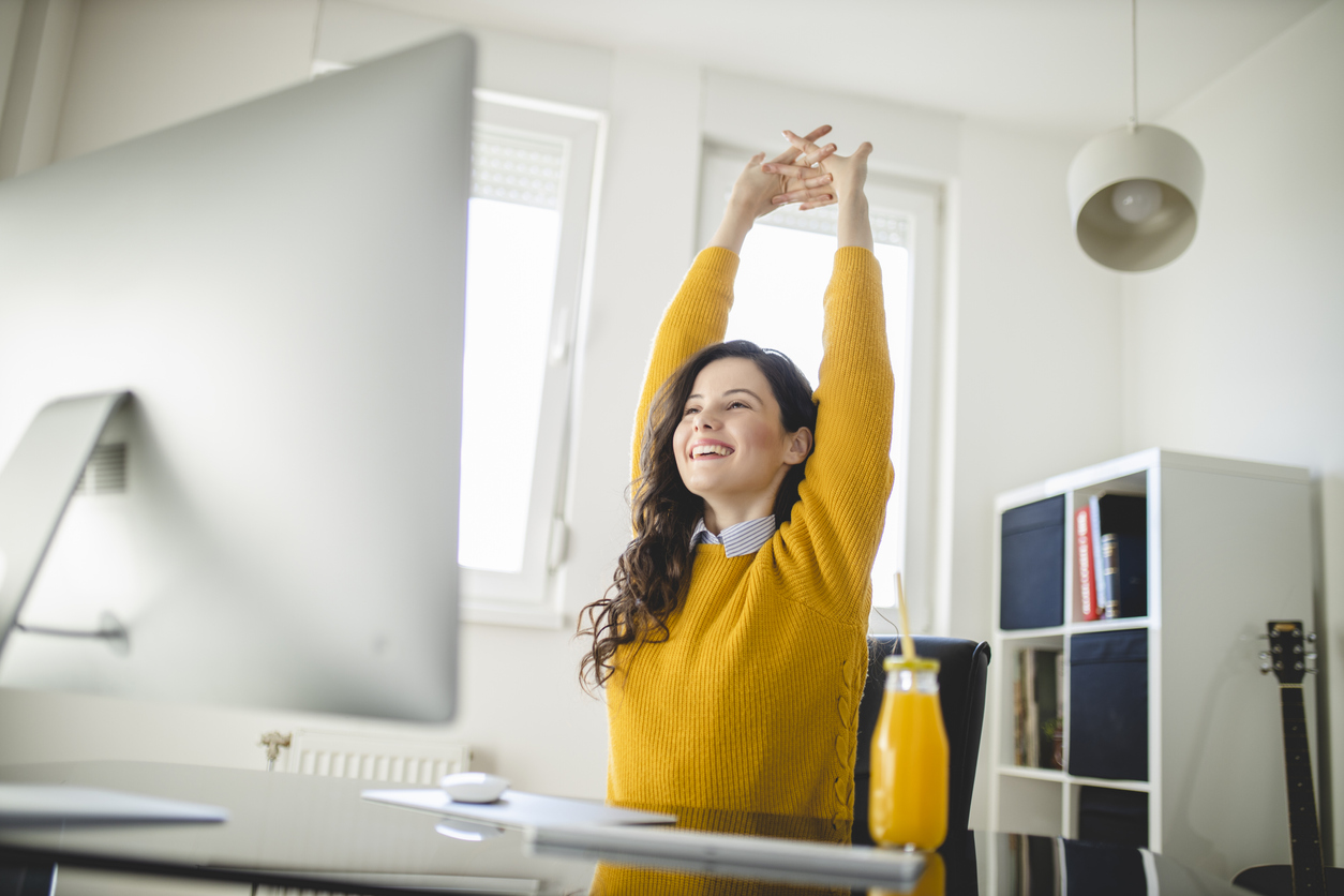 Healthy employee doing stretches at desk