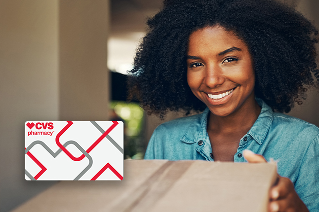 Smiling woman using CVS Pharmacy gift card to get essentials