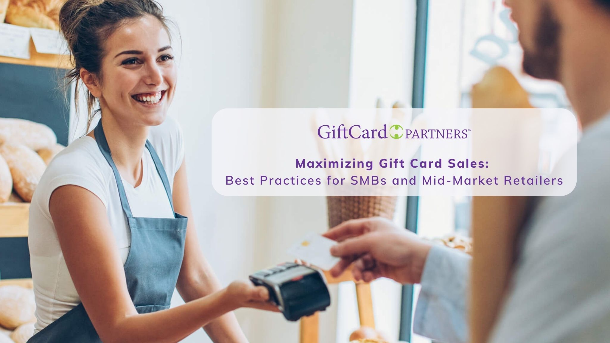 Smiling retailer handing payment reader to satisfied customer