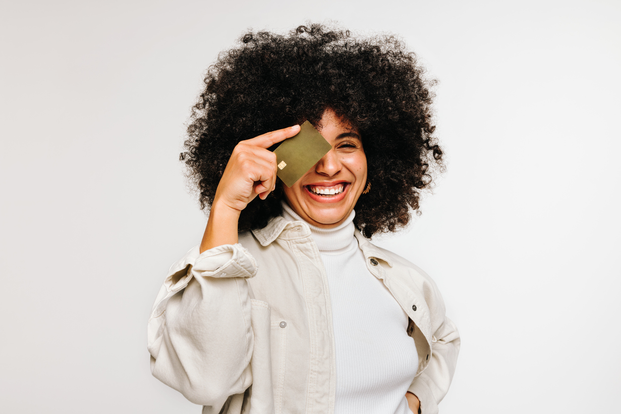 Loyal customer holding gift card reward and smiling