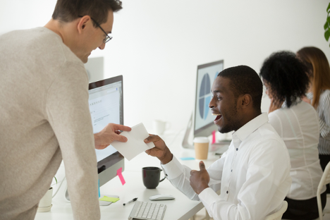 Excited employee receiving open enrollment incentive from manager